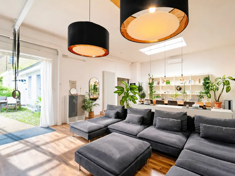 Bright living area in the industrial loft with sofa and smart TV